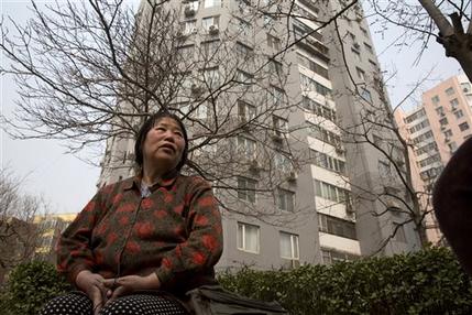 In this photo taken Monday, March 16, 2015, Chen Shuhong is interviewed in front of the residential compound where she rents out apartments as housing for cancer patients in Beijing. These so-called cancer hotels that dot the neighborhood around China's most renowned cancer hospital, give patients an affordable, cozy place to wait for appointments and undergo outpatient treatment. In this photo taken Monday, March 16, 2015, Chen Shuhong is interviewed in front of the residential compound where she rents out apartments as housing for cancer patients in Beijing. These so-called cancer hotels that dot the neighborhood around China's most renowned cancer hospital, give patients an affordable, cozy place to wait for appointments and undergo outpatient treatment.